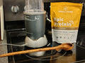 Measuring spoon in use with blender and protein powder