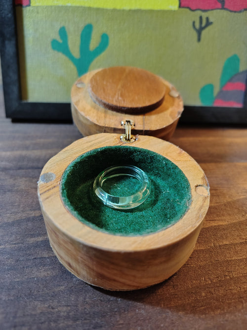 Ring box open showing green felt interior