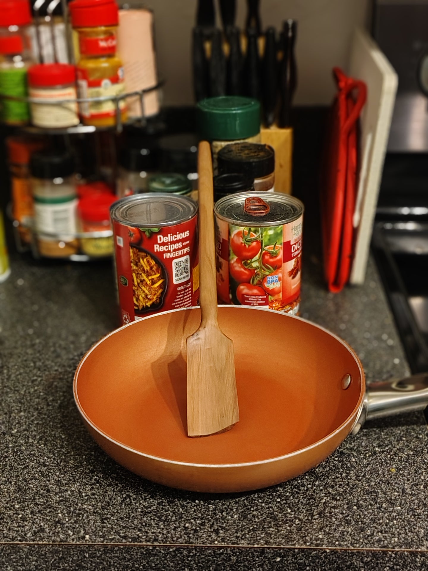 Saucepan spatula resting in a copper pan